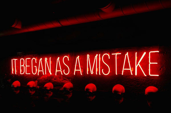mistake | Gardens with Wings Red neon sign reads'It began as a mistake'