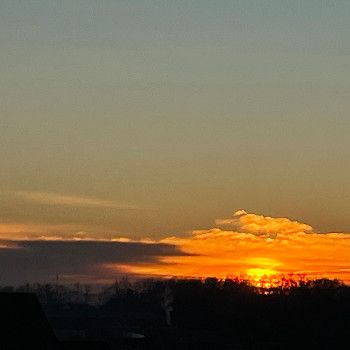 Sunrise with sunrays reflecting an orange sky